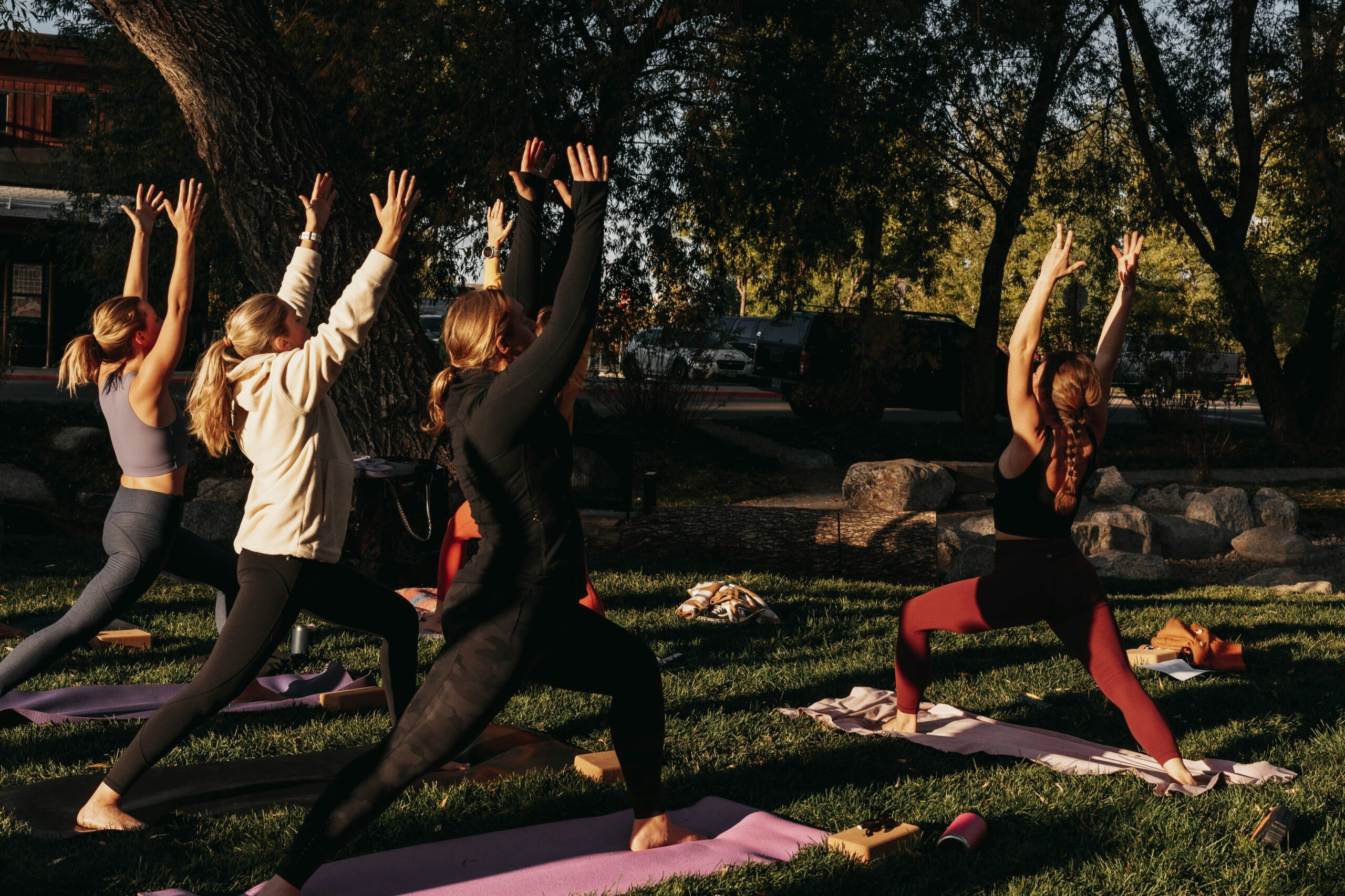 A person doing yoga outdoors with scenic mountain views behind them.