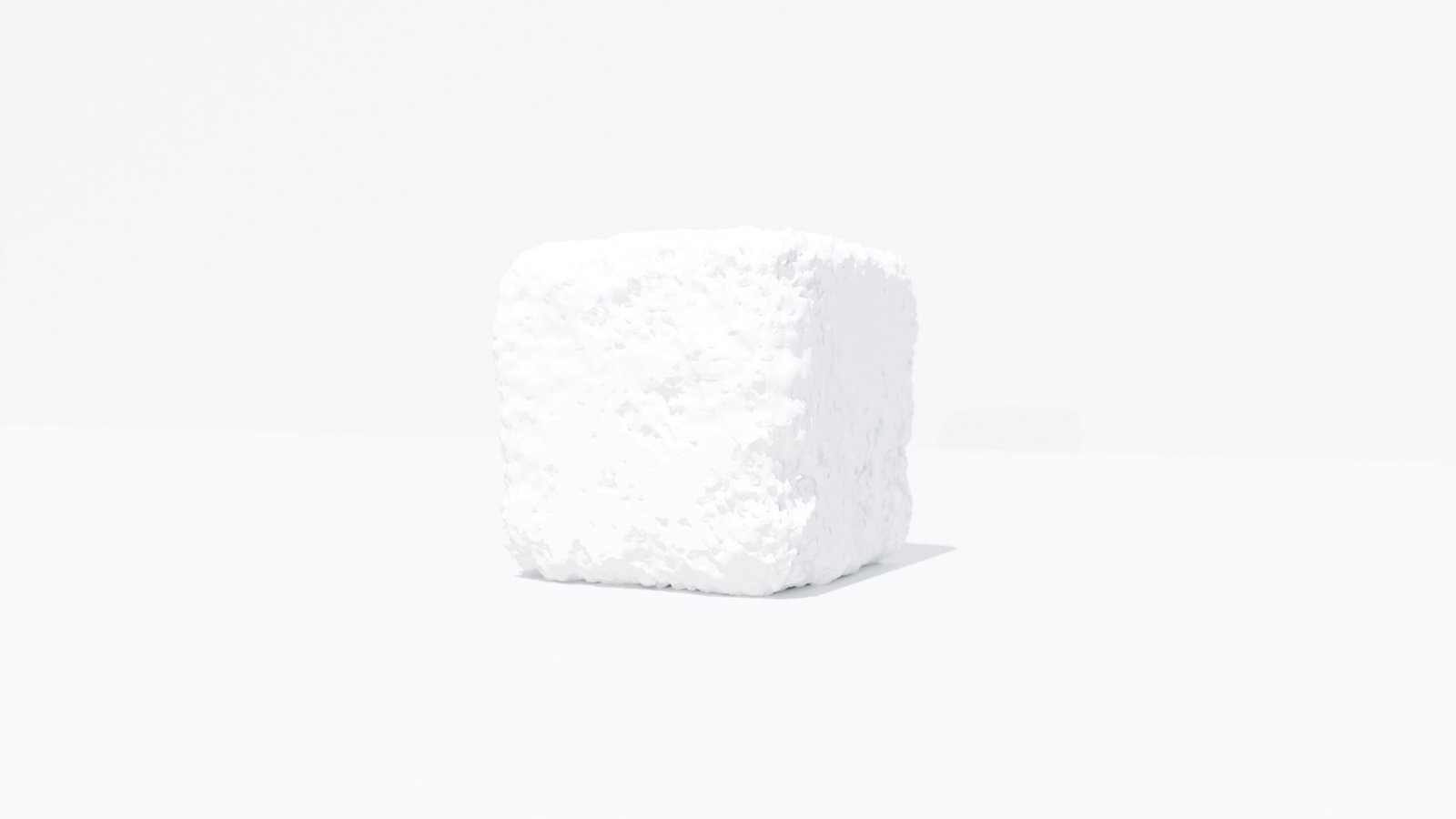 a white cube of sugar on a white surface