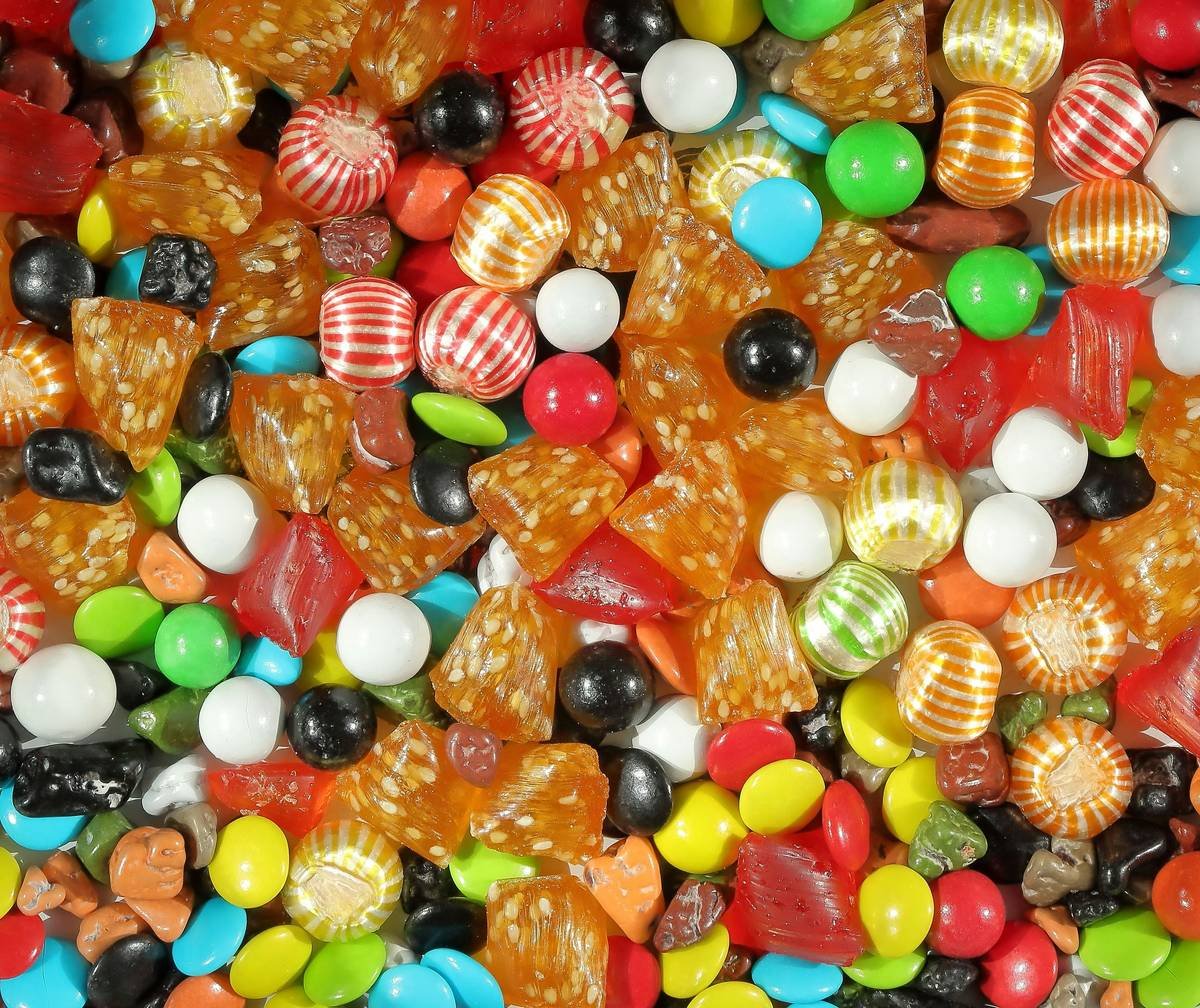 Diagram showing gymnemic acids binding to sweet taste receptors on tongue papillae, blocking sugar molecules from activating them