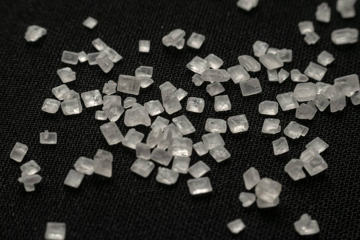 Close-up shot of refined sugar crystals on a black background