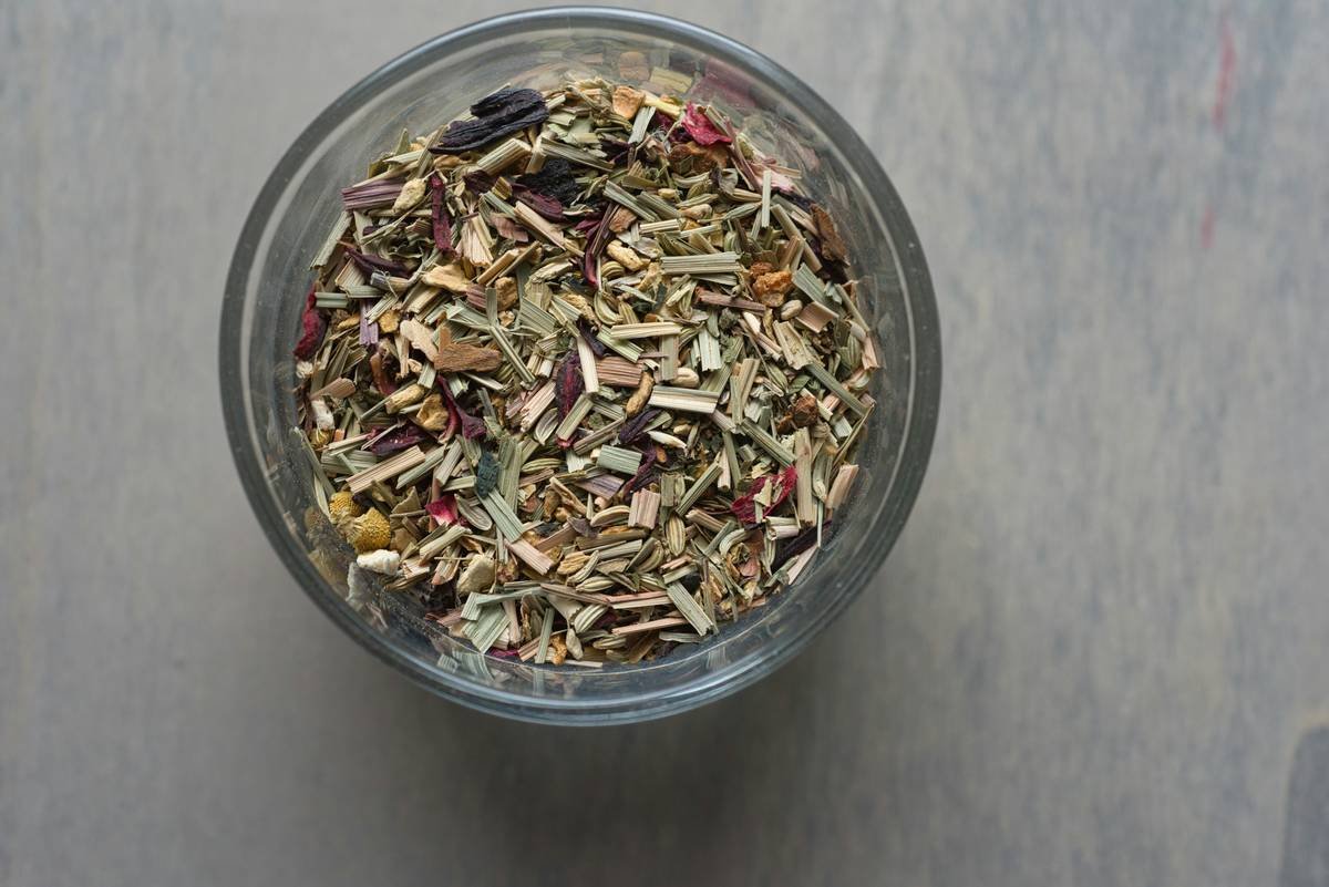 harmony weight gymnema sylvestre capsules beside fresh leaves on wooden table