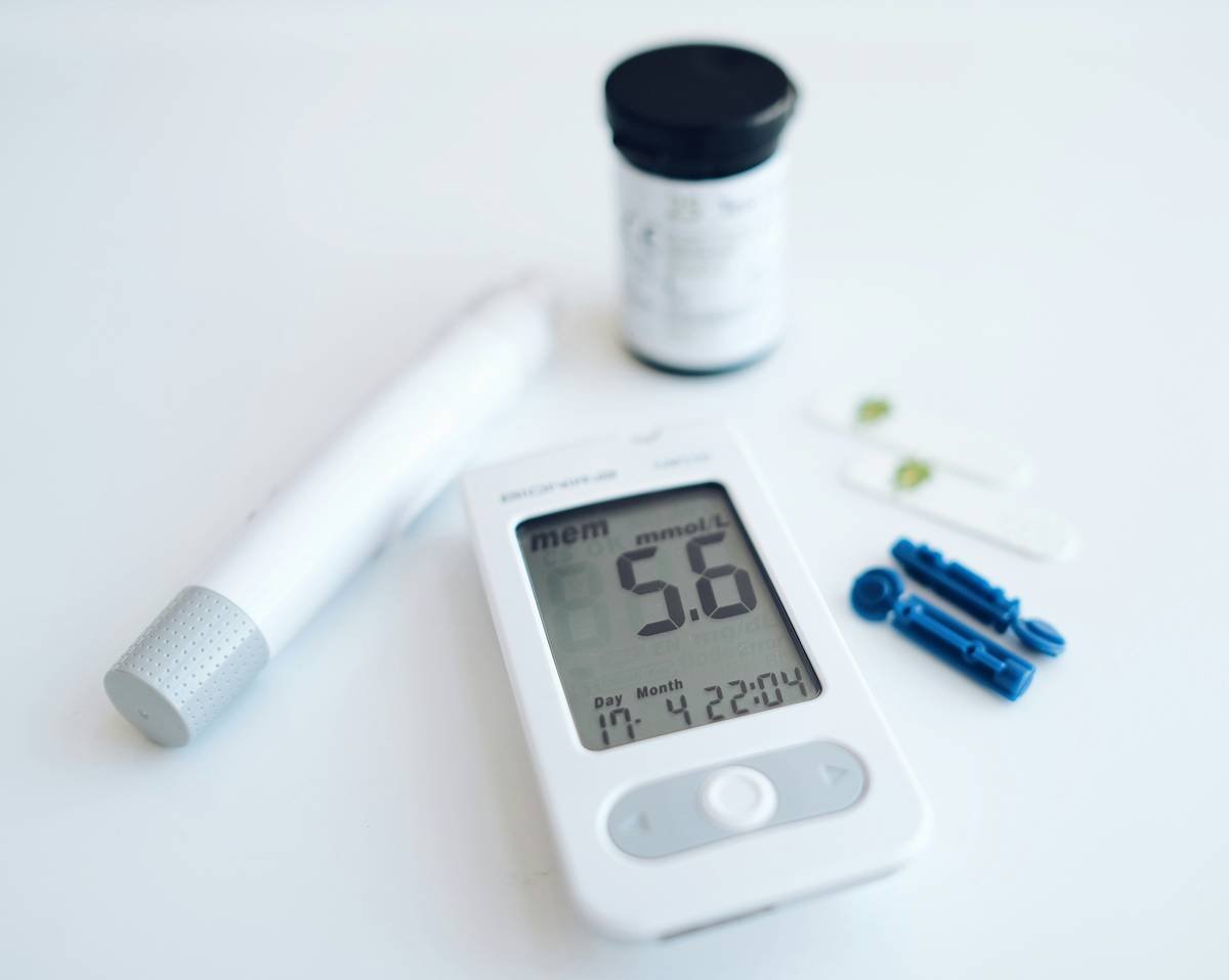 Gymnema diabetes type 2 herbal supplement bottle next to blood glucose monitor